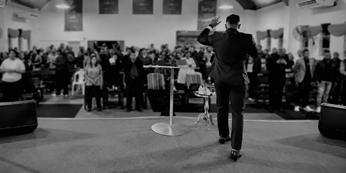 Speaker on stage addressing an audience
