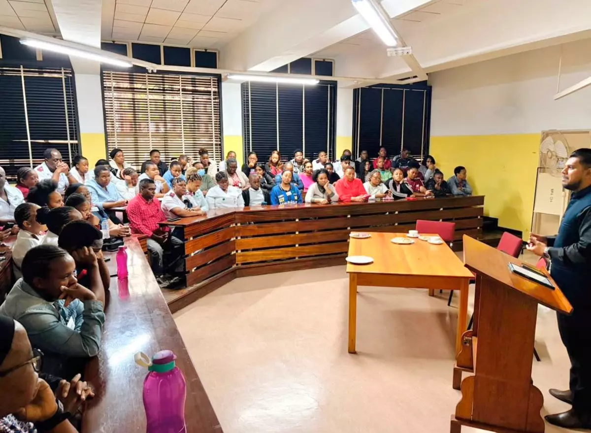 Speaker presenting to a large audience in a tiered lecture hall